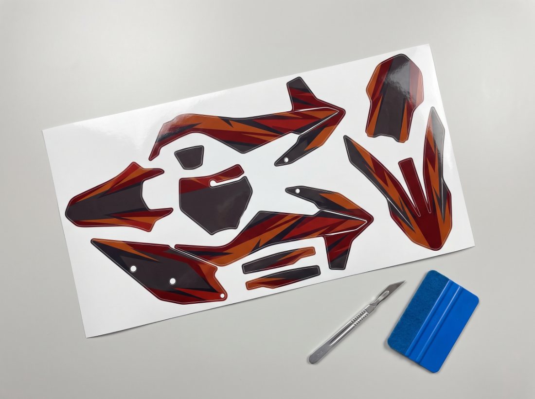 A die-cut sheet of printed motocross vinyl panels